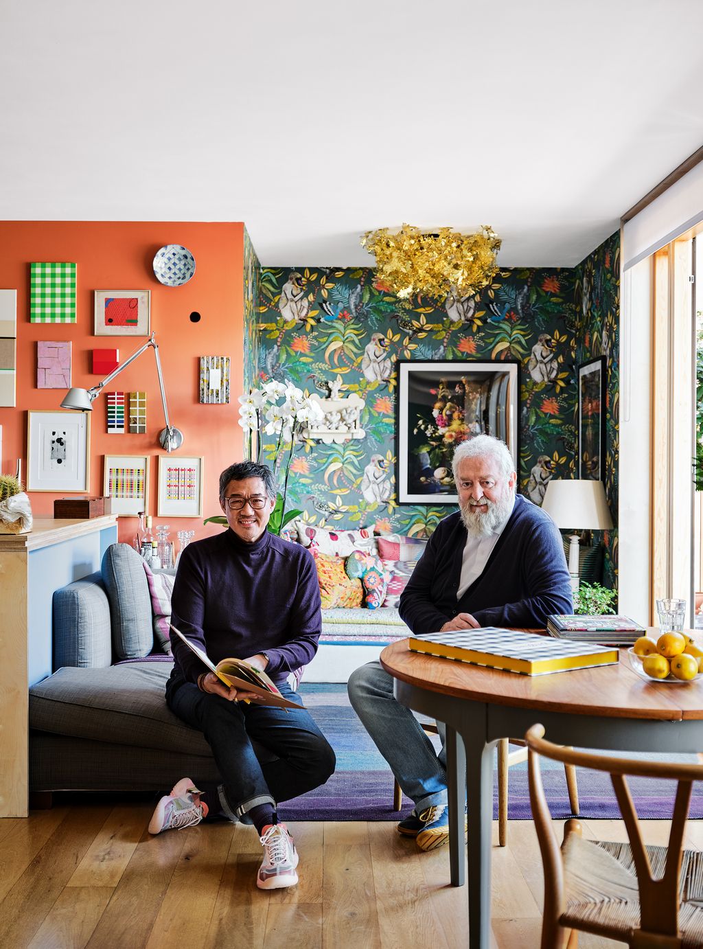 Image may contain Clothing Shoe Footwear Apparel Human Person Furniture Chair Sitting Living Room and Indoors