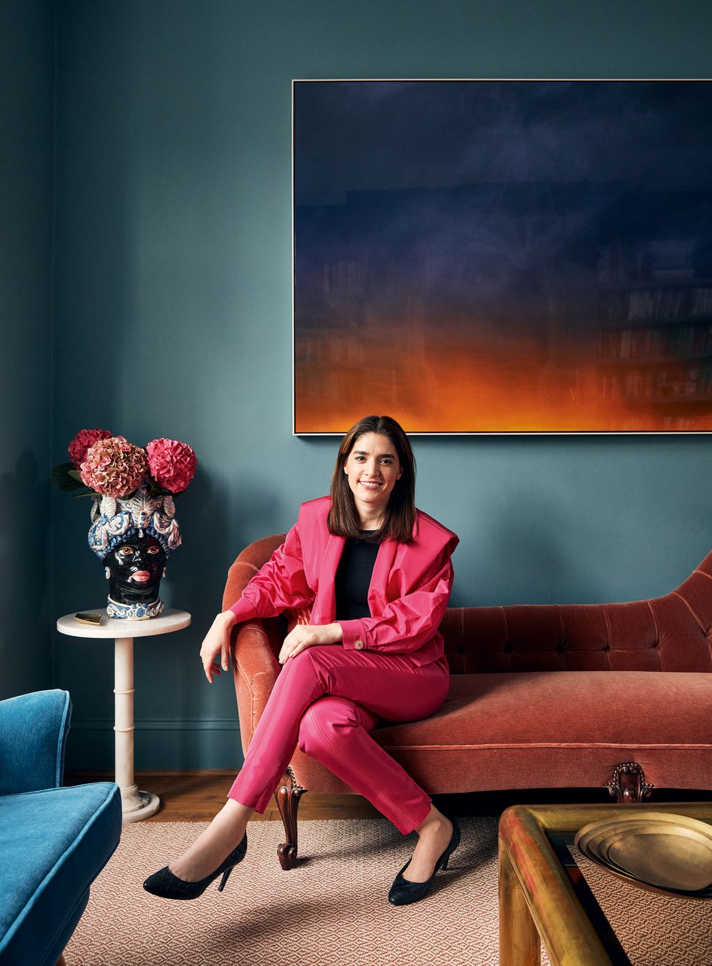 Image may contain Furniture Couch Sitting Human Person Plant Living Room Indoors Room Clothing and Apparel