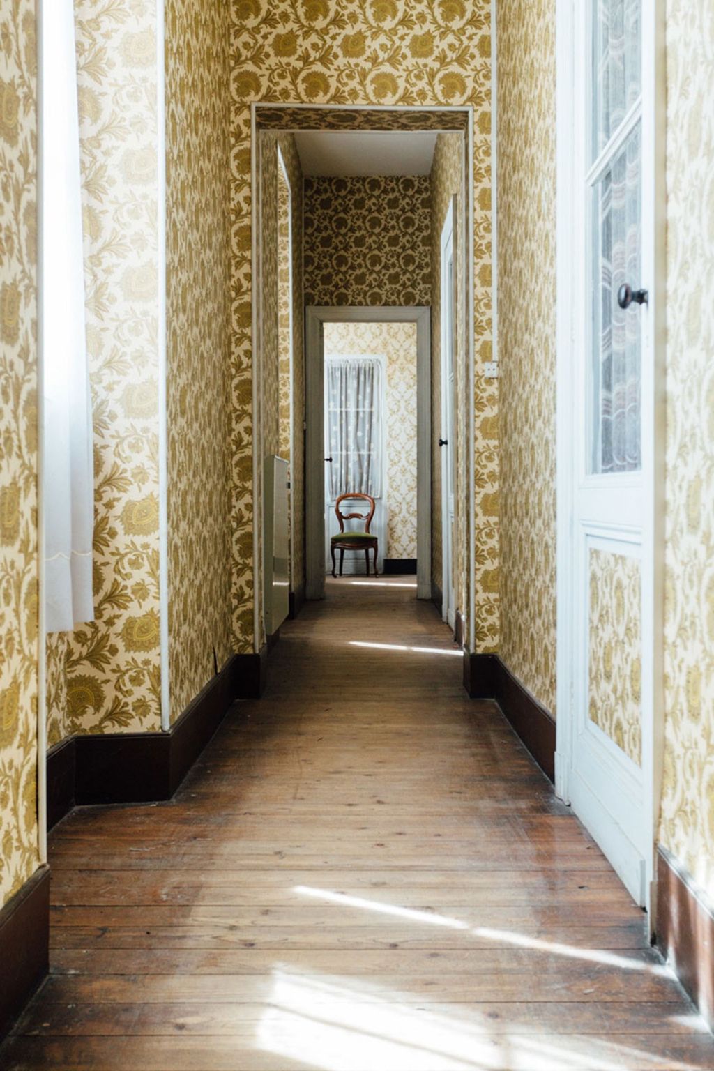 Image may contain Flooring Floor Corridor Interior Design Indoors Furniture and Chair