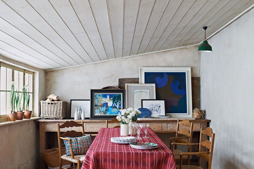 Image may contain Furniture Living Room Room Indoors Home Decor Interior Design Table Dining Room Chair and Plant