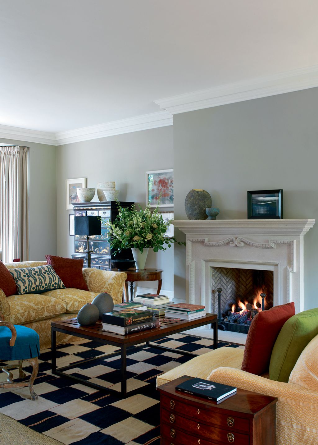 Image may contain Furniture Living Room Room Indoors Couch Table Home Decor Rug Interior Design and Coffee Table