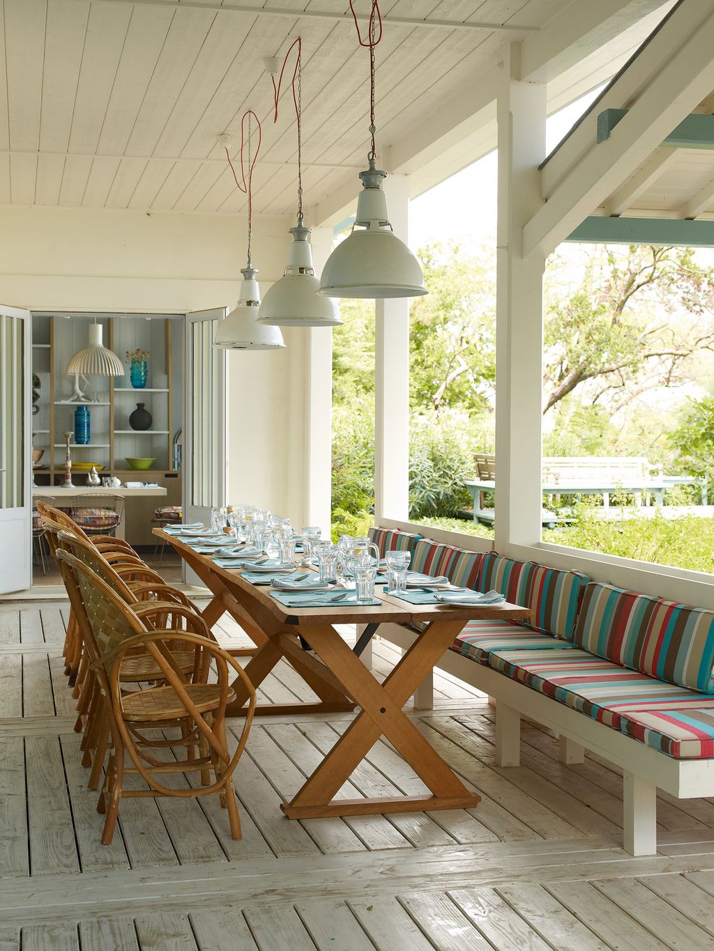 The 4.3metrelong table on the terrace was made by John Knuckey from a single length of oak above it hang pendant lights...
