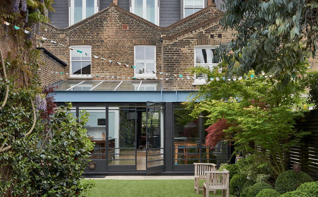 The toplit kitchen spreads across the full width of both original houses with bespoke french windows opening onto the...