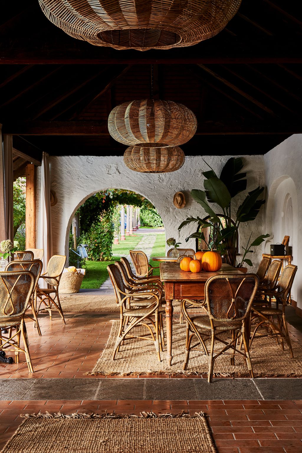 Rattan chairs and lampshades bring a relaxed rustic touch to Villa Arnicas pool house.