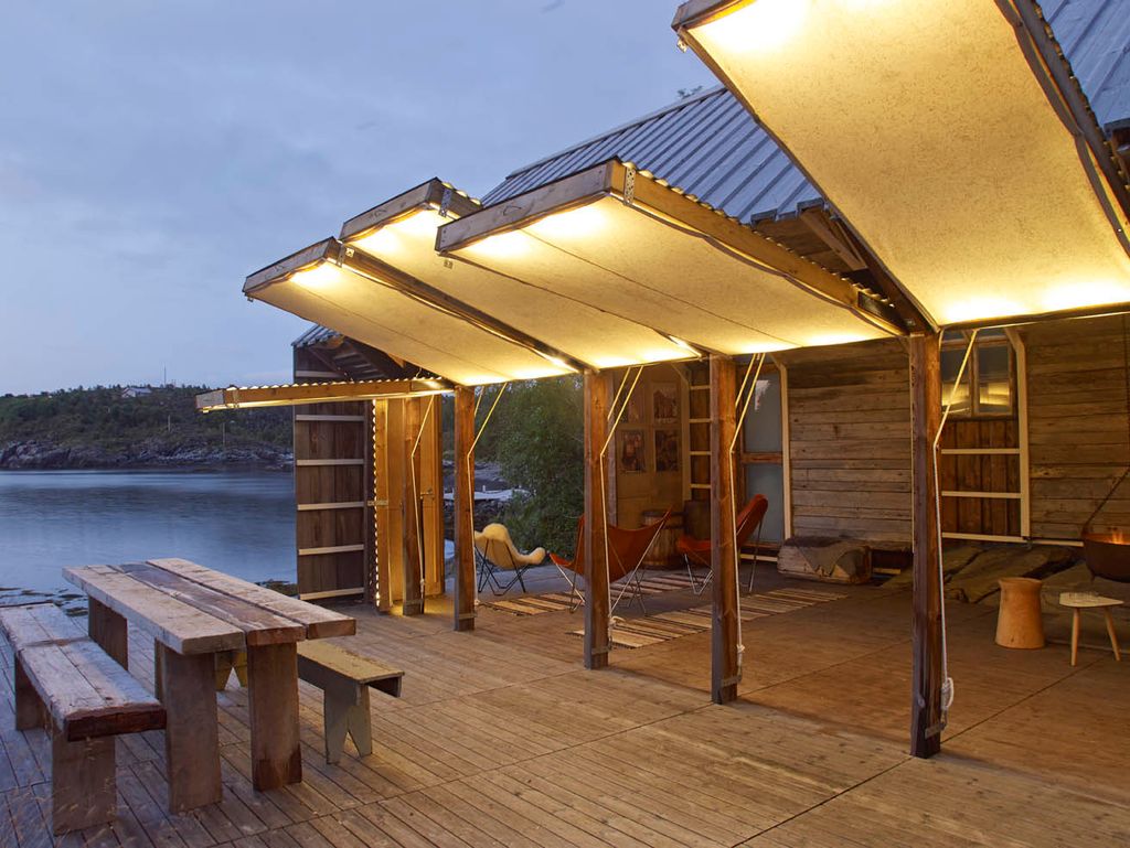 An entire side of this Norwegian cabin  built to look like a boathouse  opens up to let in light and fresh lakeside air....
