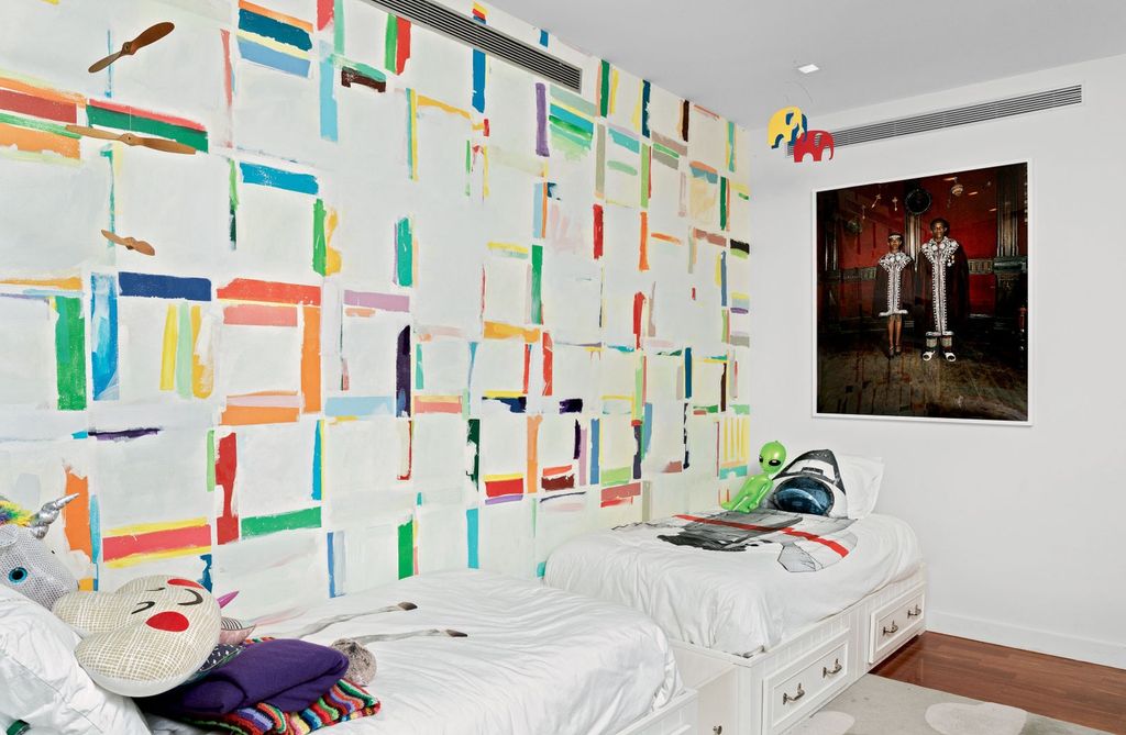 In a shared kids bedroom a colorful mural painted by artist Matt Wycoff who cocurated “Young Gifted and Black” alongside...
