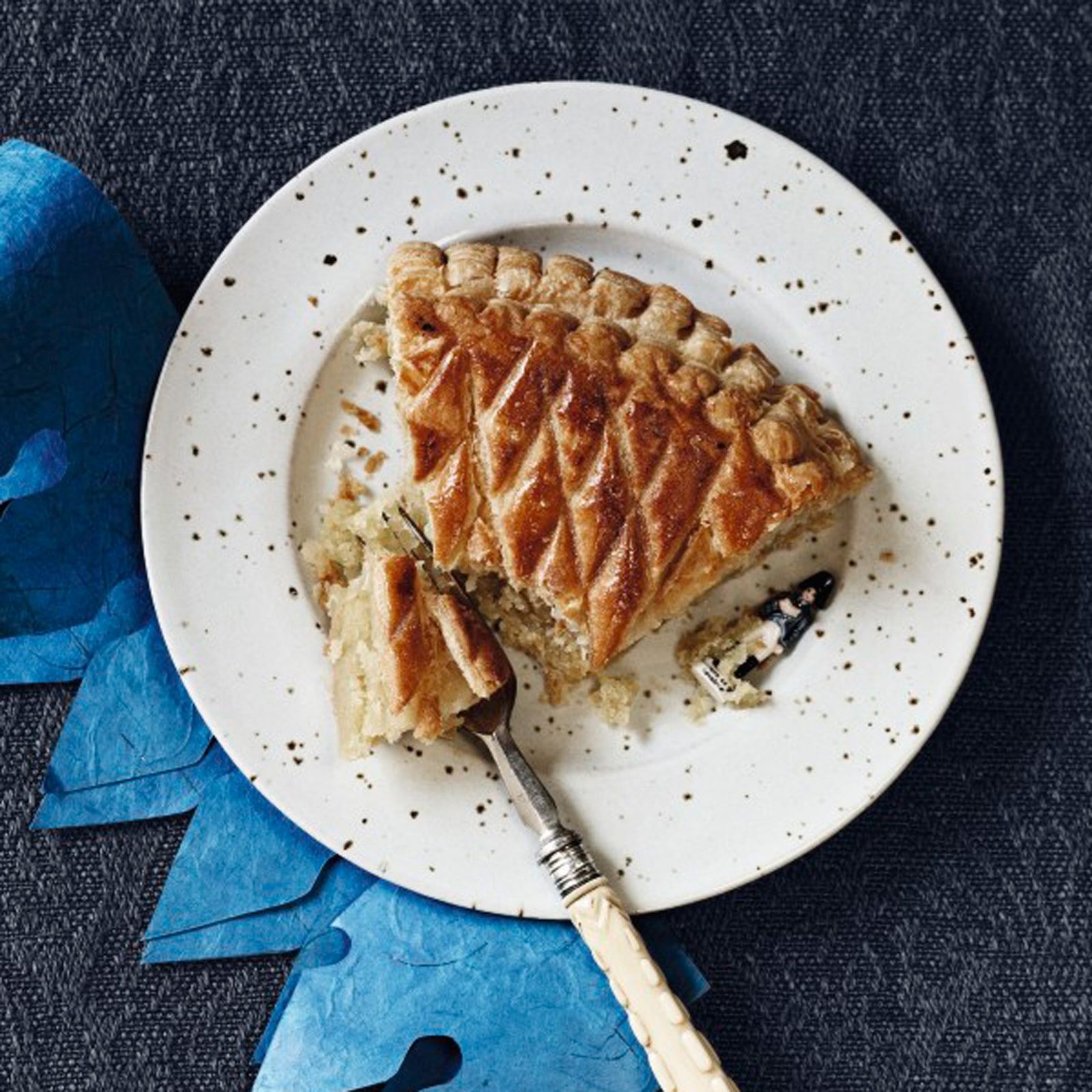A slice of galette des rois. The fêve  is a miniature toy soldier.