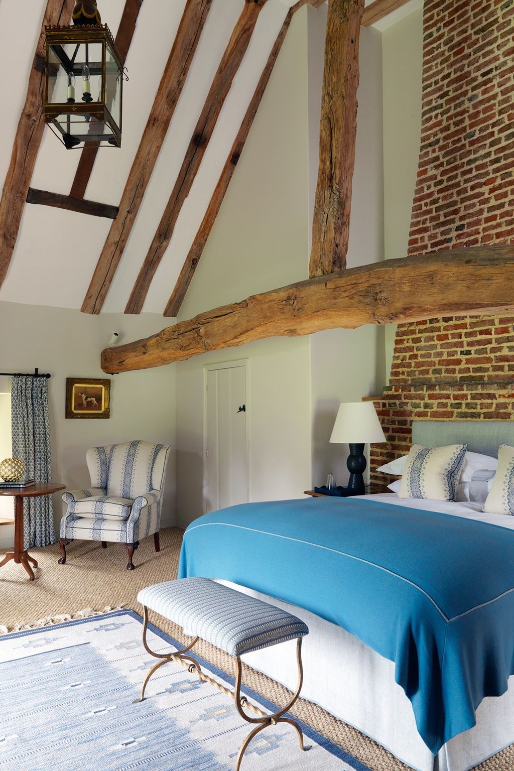 A brick wall and charasmatic lantern mix the trendy and urban with the serenity of this country retreat.