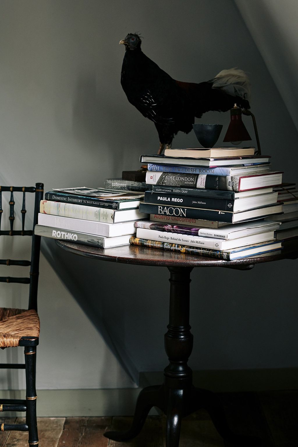 Image may contain Furniture Animal Bird Poultry Chicken Fowl Bookcase and Shelf