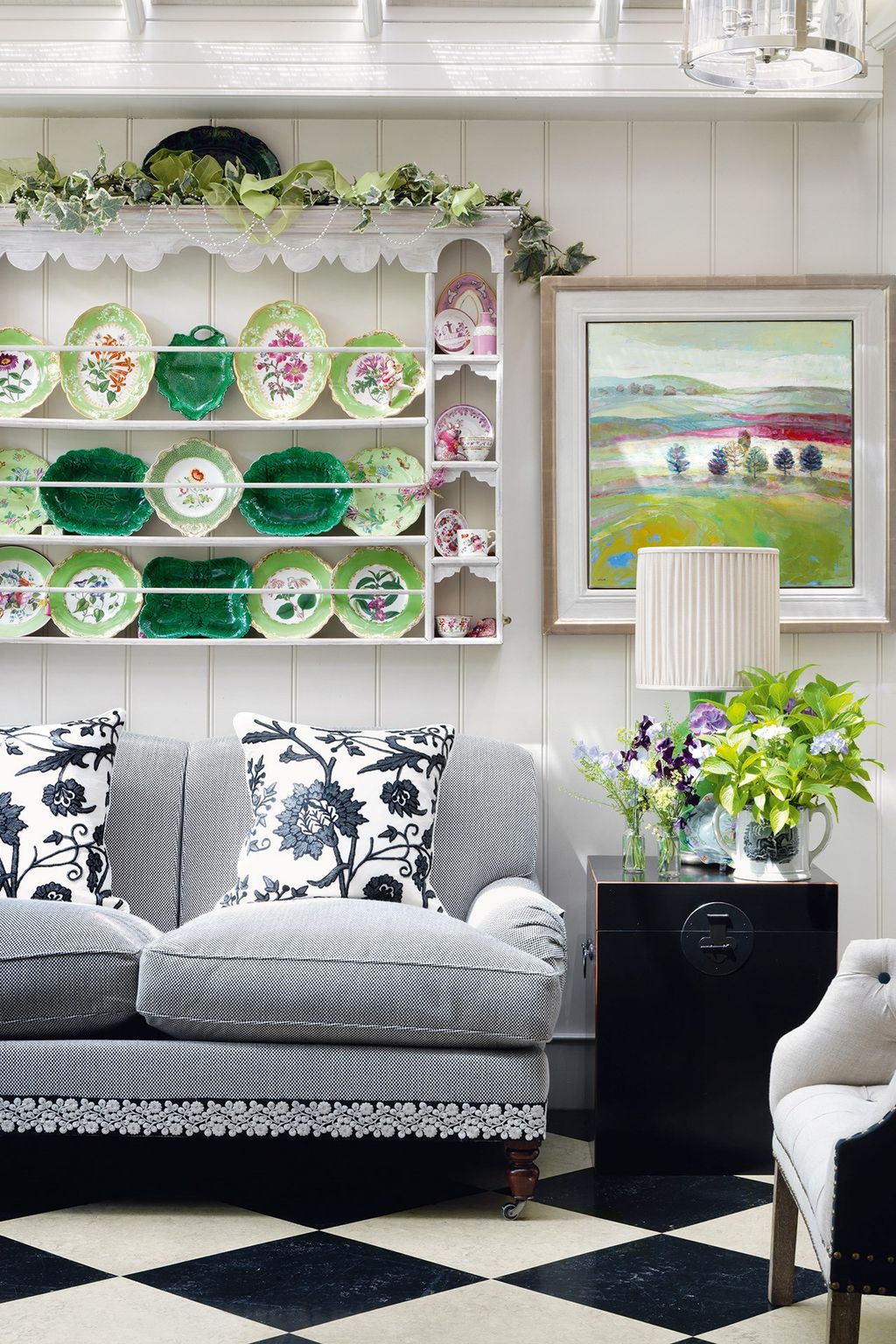 Black and white flooring in oversize checks unites the the kitchen and conservatory. 'I blame the floor' she says...
