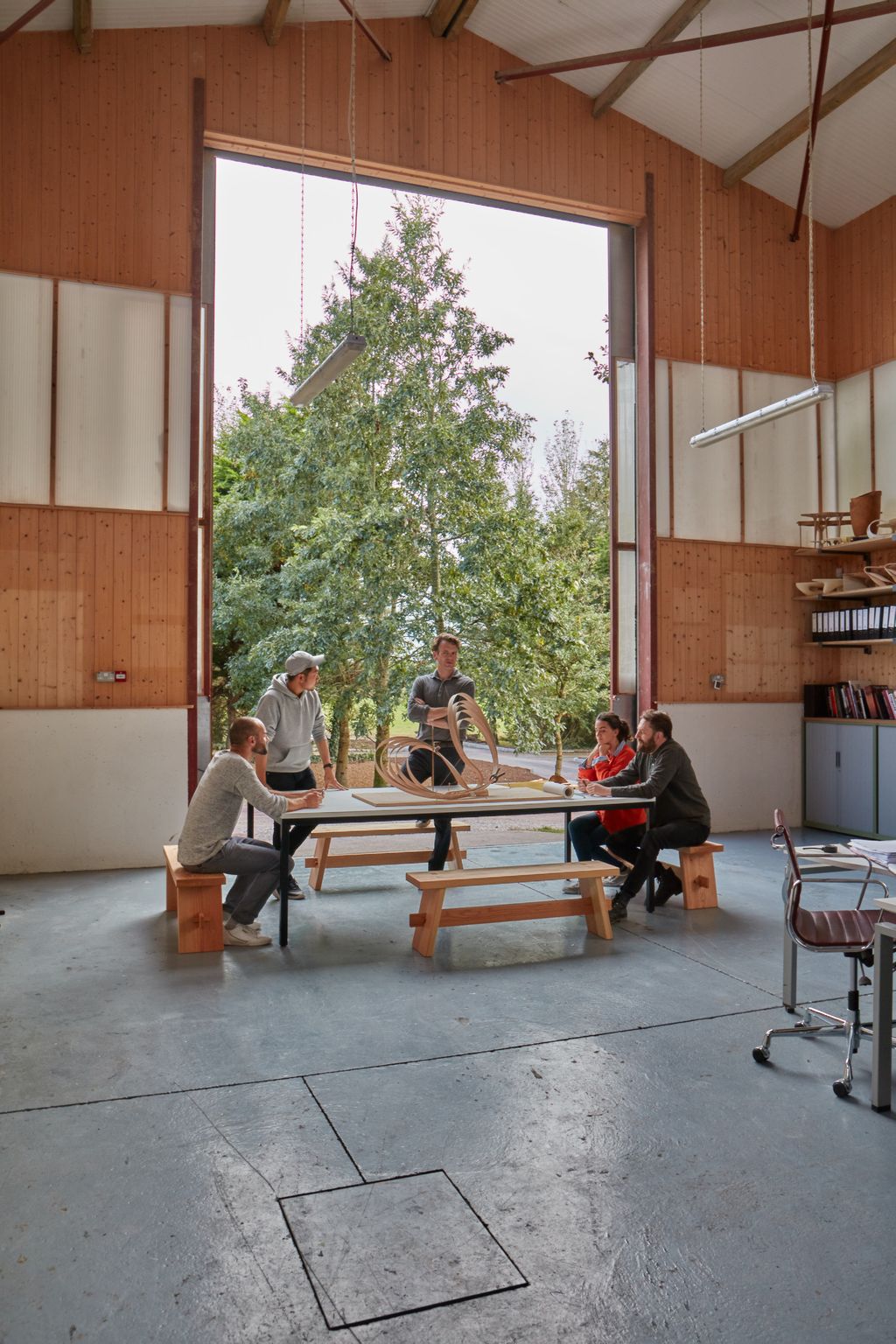 Image may contain Clothing Shoe Footwear Apparel Wood Human Person Furniture Chair Plywood Tabletop and Flooring