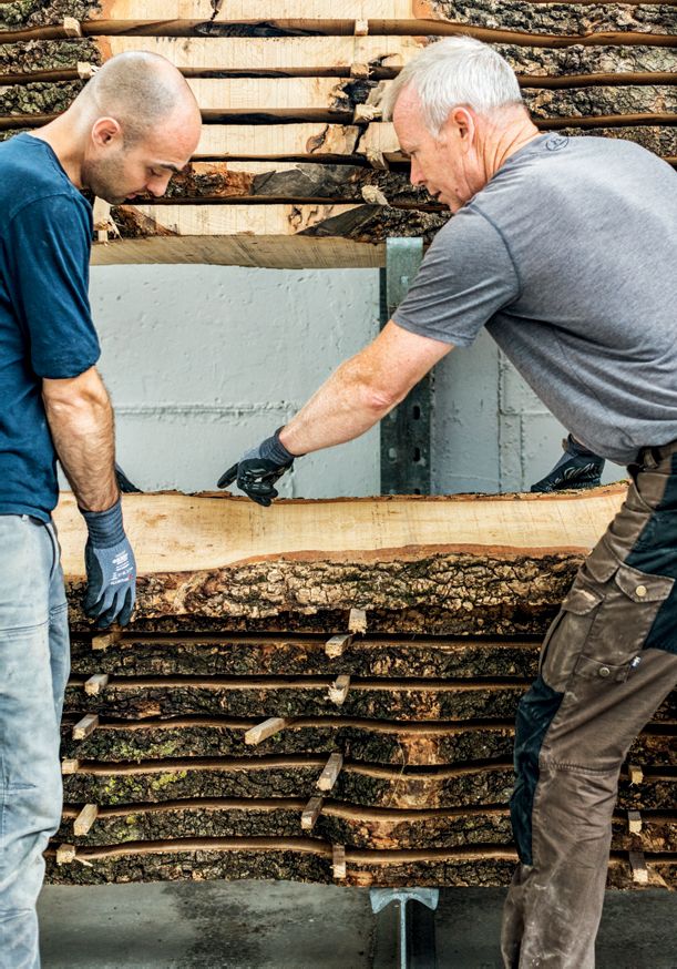 Image may contain Human Person Pants Clothing Apparel Soil Brick Carpenter and Wood