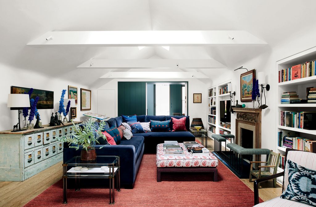 Cushions by Susan Deliss brighten a sofa designed by Todhunter Earle. An ottoman in a Vaughan fabric and a rug from...