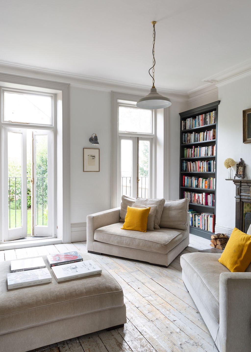 Image may contain Furniture Living Room Indoors Room Table Coffee Table Rug Cushion and Pillow