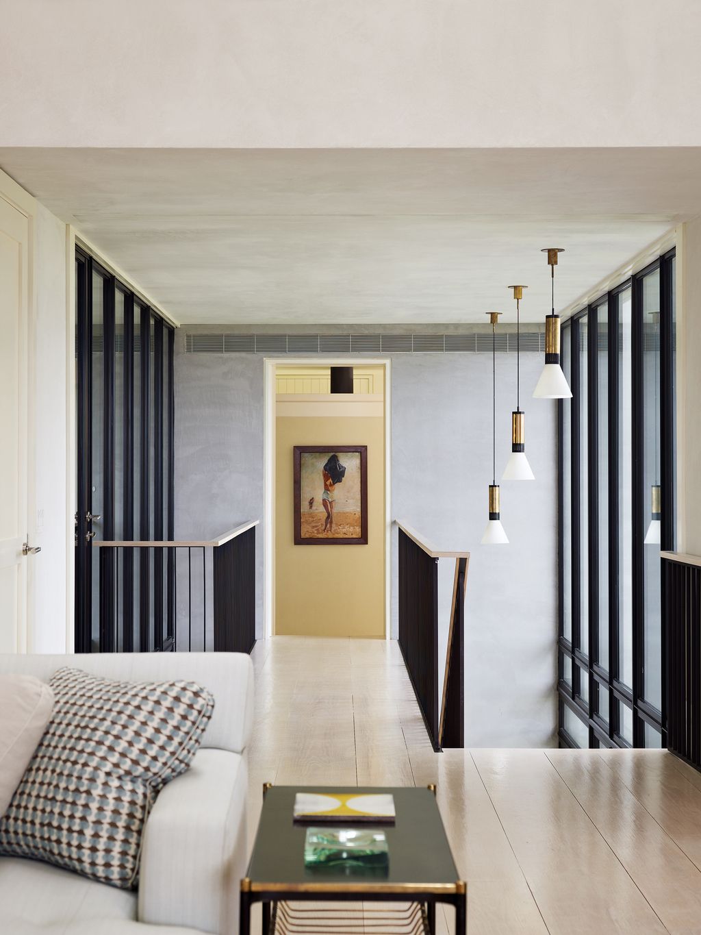 A bridge leads from the sitting area to the main bedroom suite the lights hanging over the staircase are from Bernd...