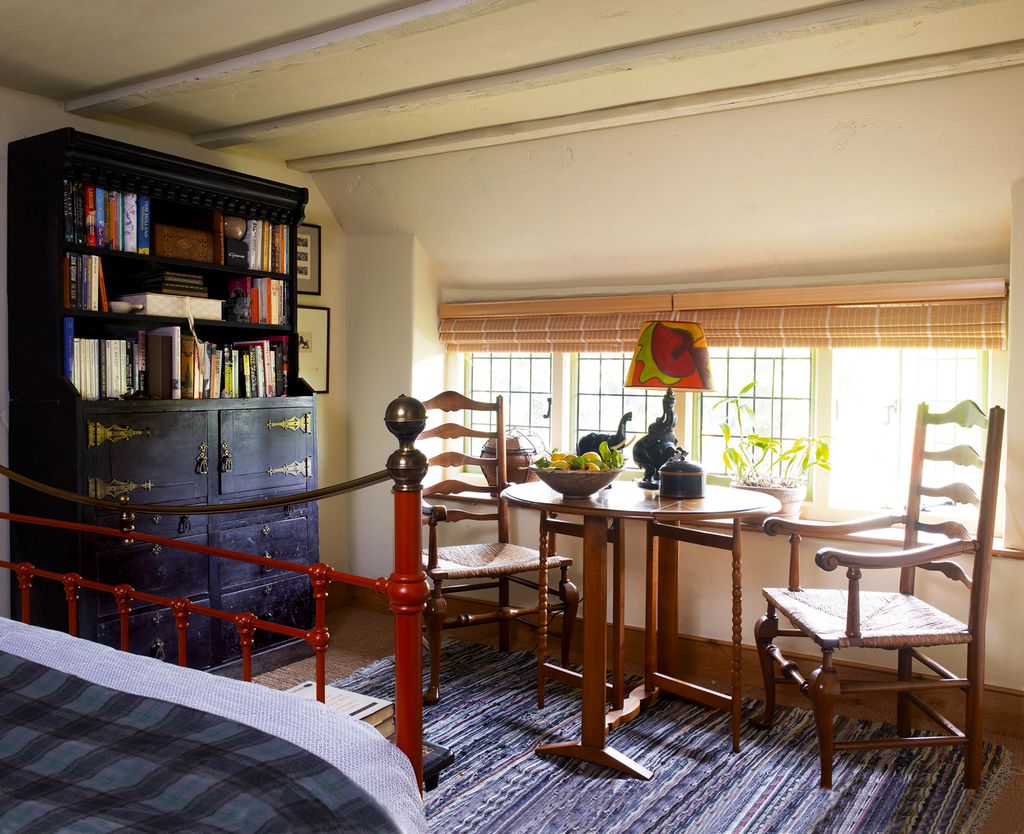 In the spare room the reproduction Victorian bedstead was painted by Philip the elephant lamp is from Sri Lanka and the...