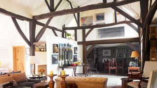 Image may contain Living Room Room Indoors Housing Building Furniture Chair Flooring Loft Lobby Wood and Table