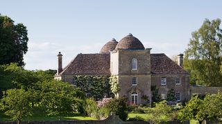 Image may contain Grass Plant Building Architecture Housing Roof and Dome