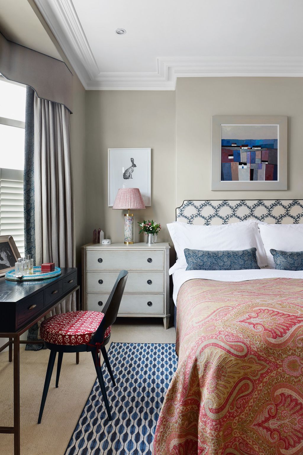 The main bedroom is furnished with a Vanderhurd wool dhurrie and a 'Duchess Paisley' bed throw from de Le Cuona the desk...