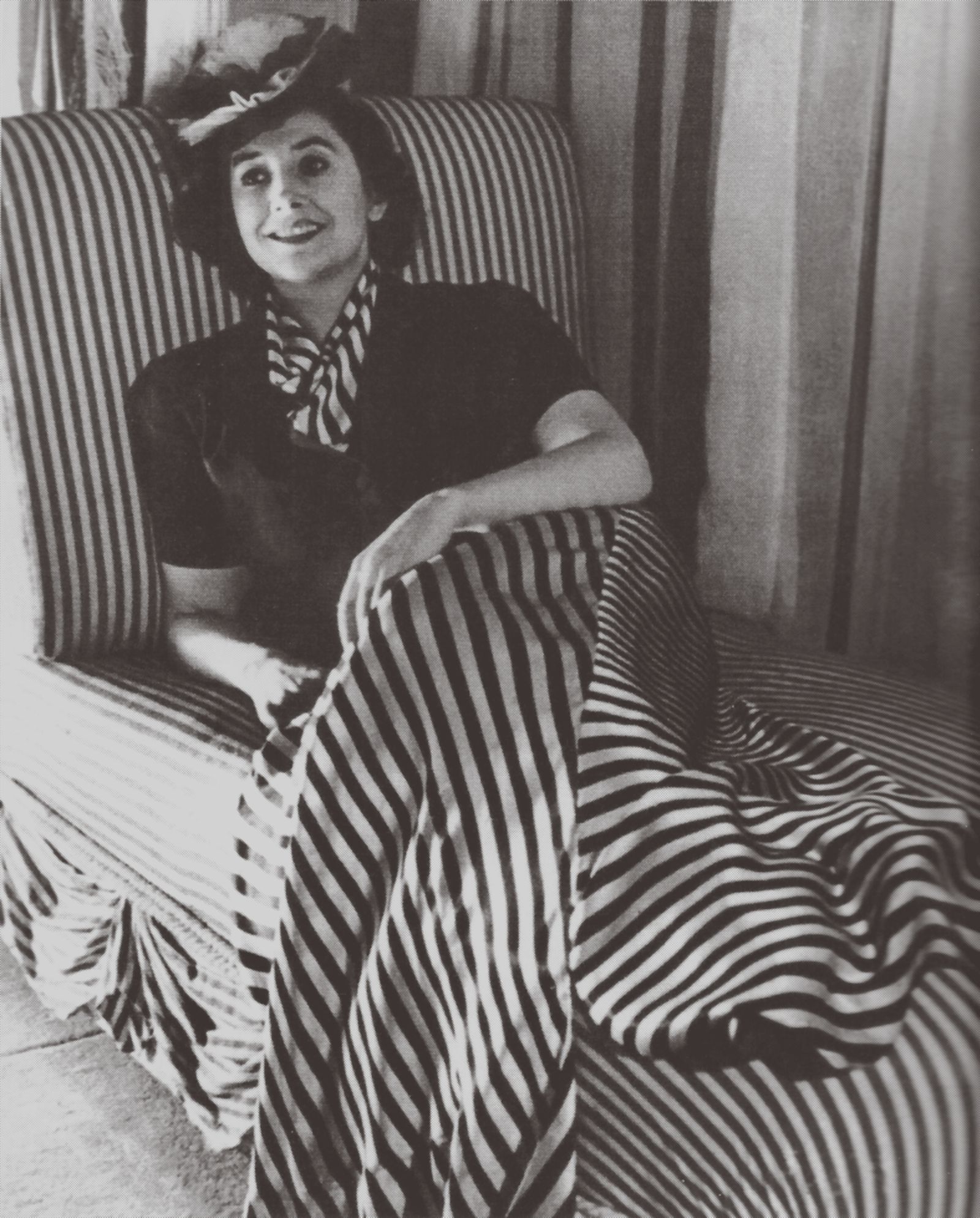 Image may contain Performer Human Person Furniture Chair Blanket and Clown