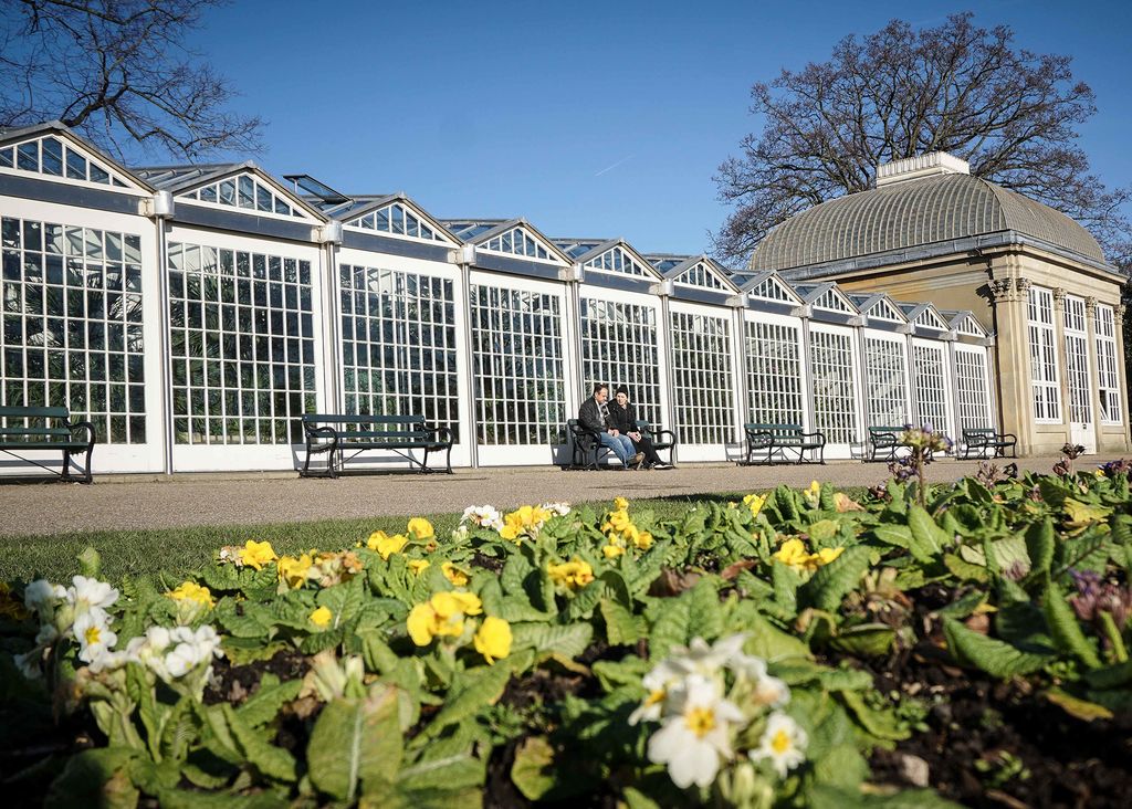 Image may contain Outdoors Garden Plant Human Person Furniture Bench Vase Pottery Potted Plant Jar and Vegetation