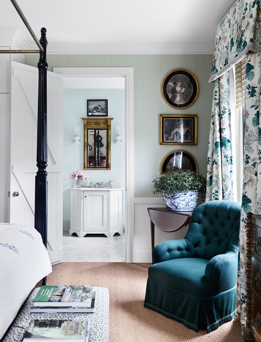 A pale green Farrow Ball wallpaper provides a calm backdrop to the darker fabrics and chintz in the main bedroom.