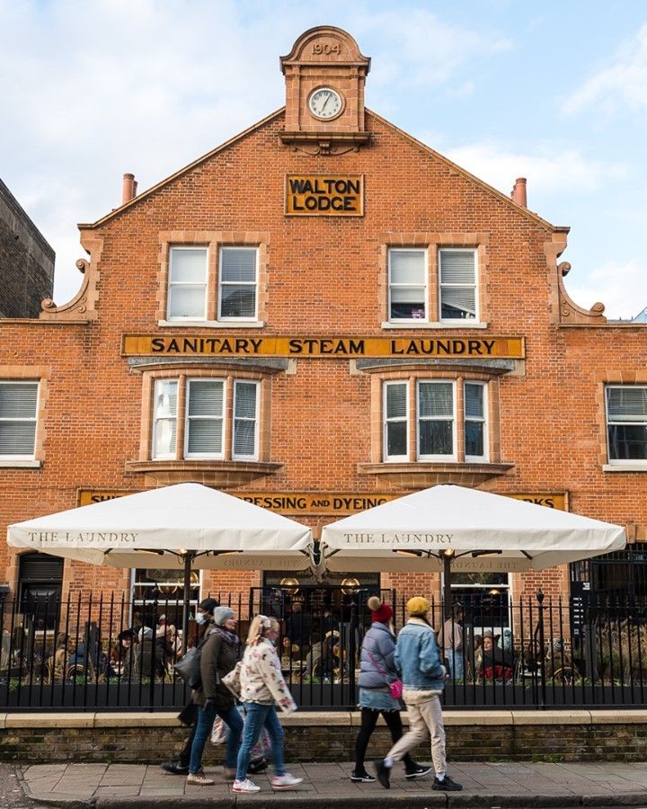 Image may contain Human Person Clock Tower Architecture Tower Building Footwear Clothing Shoe and Apparel