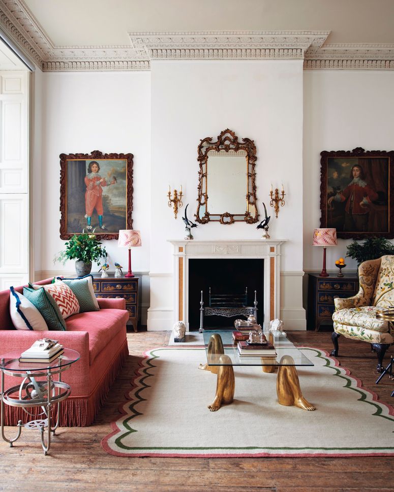 Image may contain: Furniture, Living Room, Room, Indoors, Couch, Table, Interior Design, Human, Person, Coffee Table, and Rug