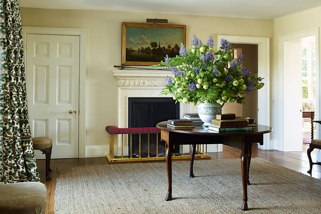 Image may contain Flooring Furniture Home Decor Living Room Indoors Room Table Floor Interior Design and Hearth