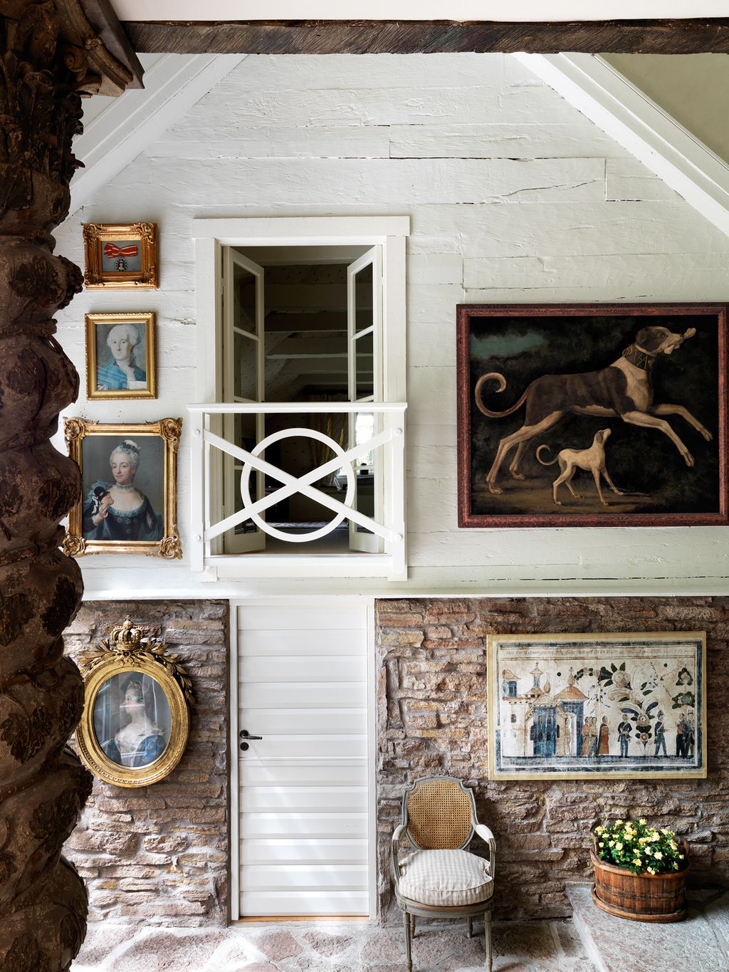 On the upper level of the barn is the main bedroom with a balcony overlooking the atrium.