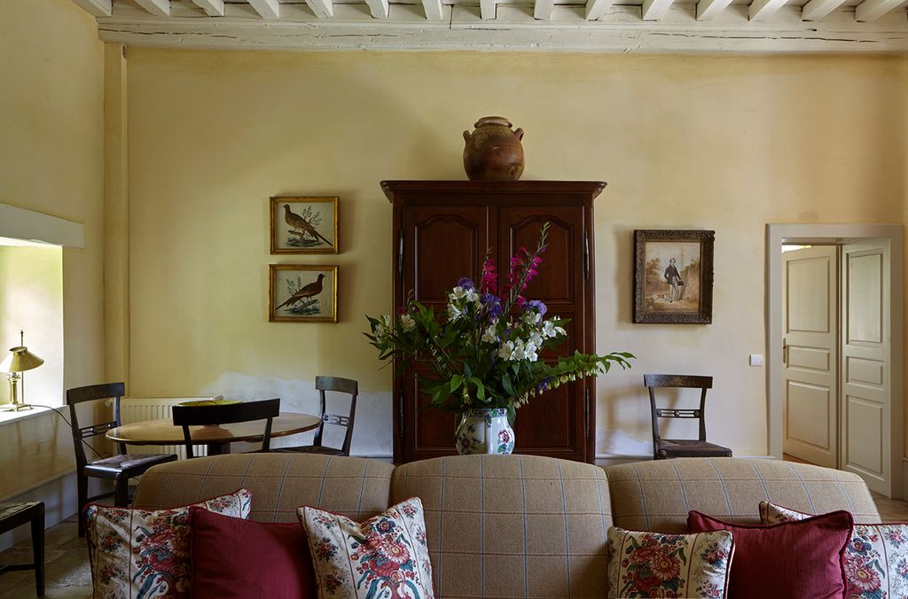 Image may contain Living Room Room Indoors Furniture Couch Cushion Pillow Home Decor Interior Design and Chair