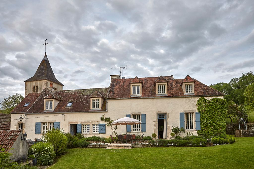 Image may contain Plant Grass Lawn Building Housing House Mansion Steeple Spire Architecture and Tower