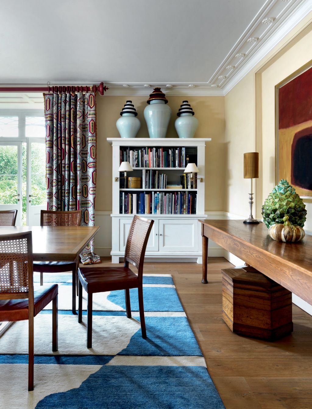The walls are painted in ‘French Sienna by Rose of Jericho. Sandy Jones designed the rug and the curtains are made from...