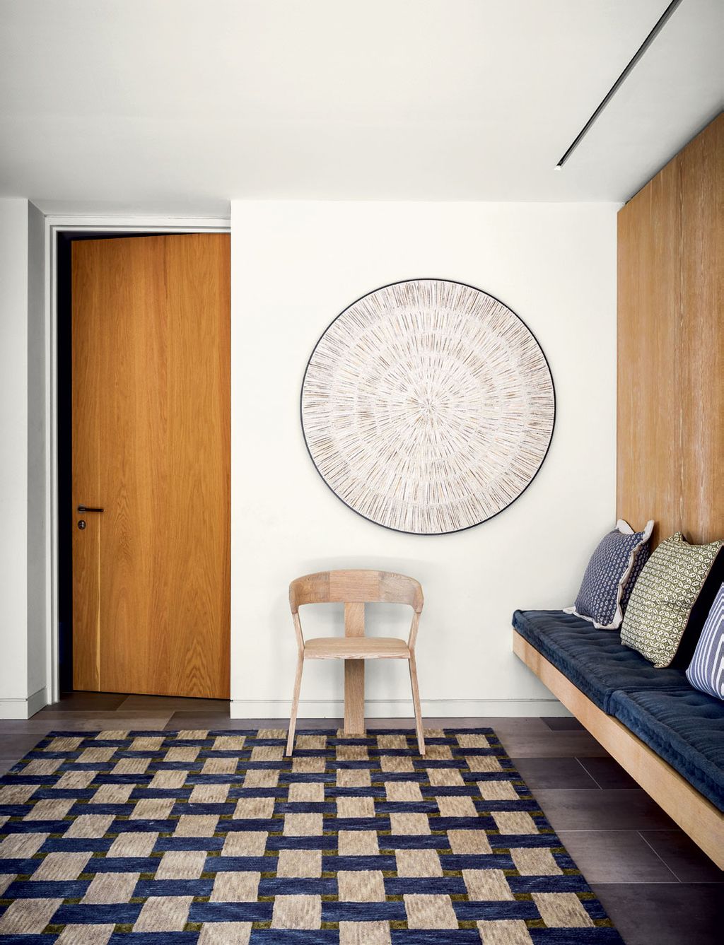 Image may contain Furniture Rug Indoors Room Wood Living Room Interior Design Couch Floor and Flooring