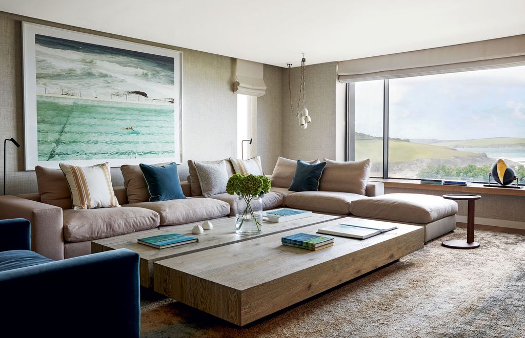 The owners painting of a swimming pool set the tone for the design of this family sitting room. The handknotted silk rug...