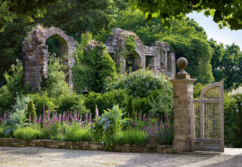Image may contain: Garden, Outdoors, Arbour, Flagstone, Plant, Gate, Patio, Flower, Lupin, and Blossom
