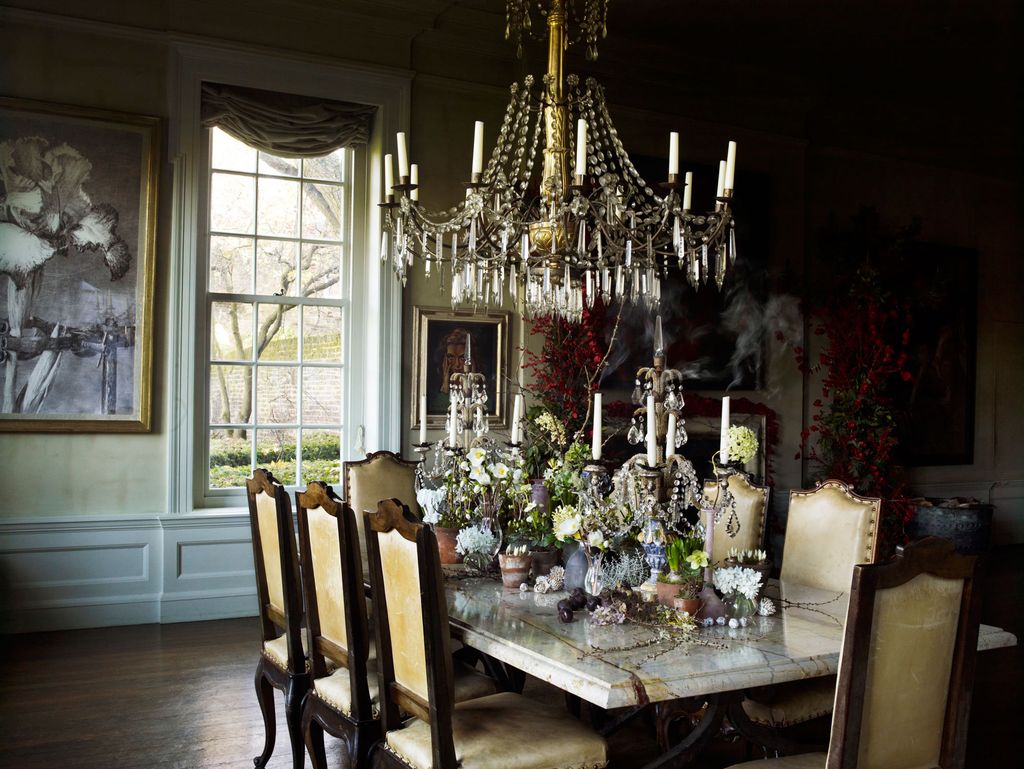 Image may contain Room Indoors Dining Room Wood Flooring Home Decor Furniture Dining Table Table Chair and Lamp