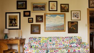 Image may contain Furniture Living Room Room Indoors Couch Table Wood Flooring Interior Design and Coffee Table