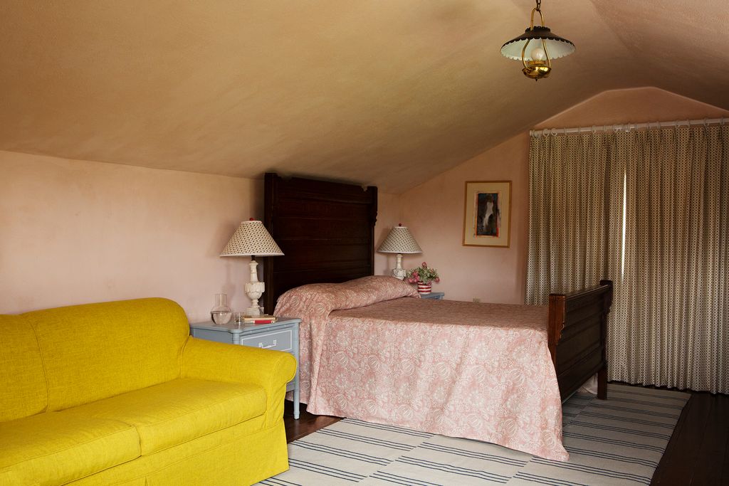 Meta brought a sense of lightness to this rather dark space with a rug from Nordic Knots curtain fabric from Howe and a...