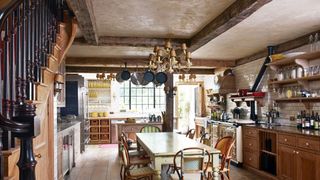 Image may contain Wood Furniture Chair Hardwood Room Indoors Kitchen Flooring Interior Design and Kitchen Island