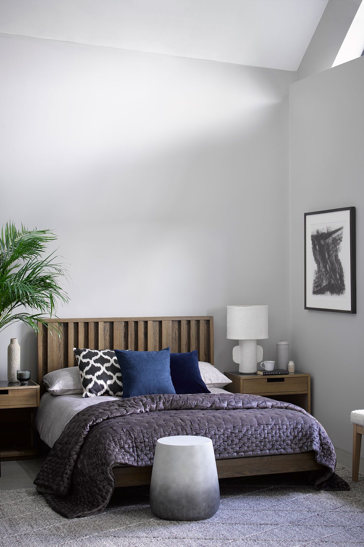 Image may contain Room Bedroom Indoors Furniture Living Room Rug Bed and Plant