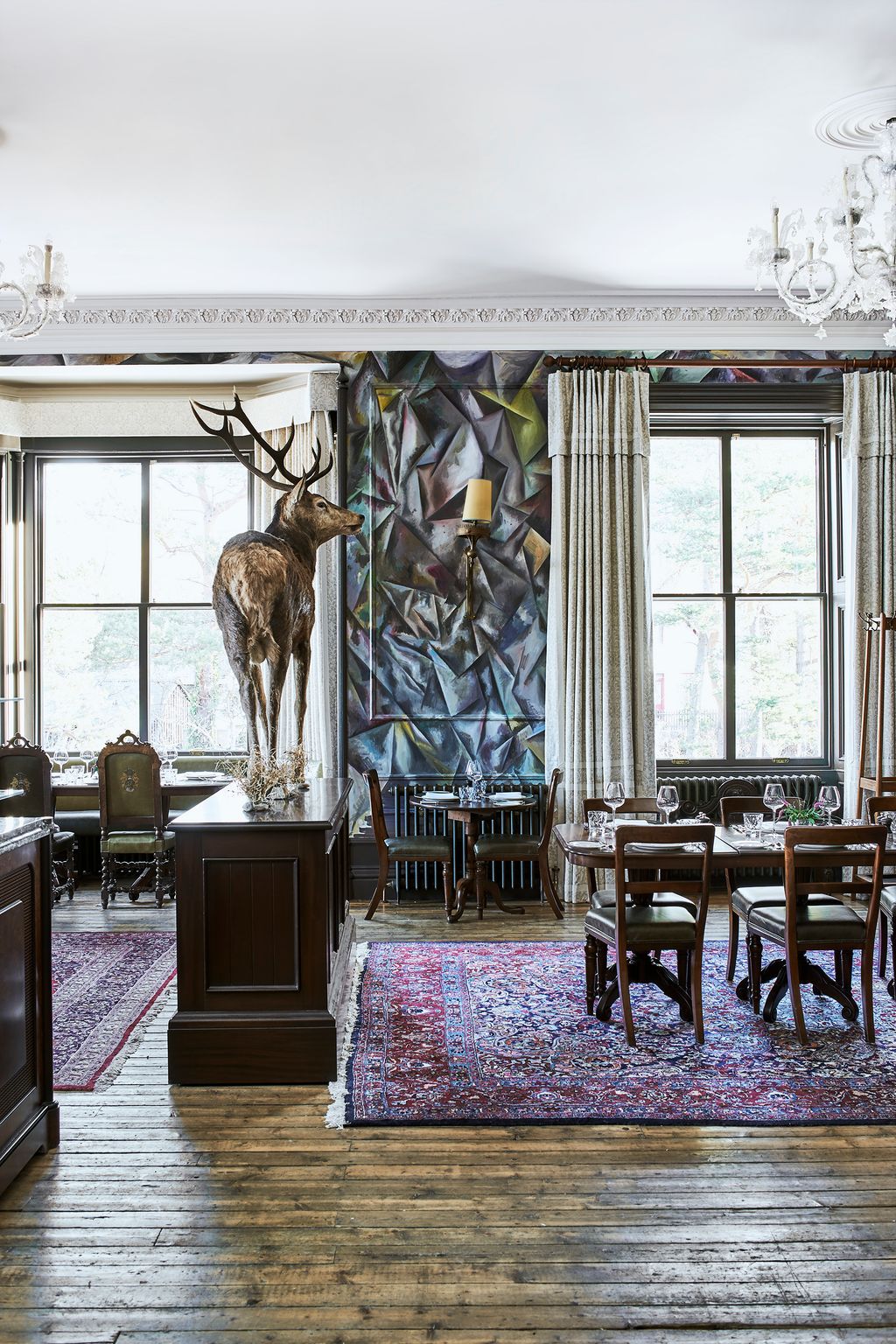 A magnificent taxidermy stag also makes a striking focal point in the Clunie Dining Room where the walls are wrapped in...