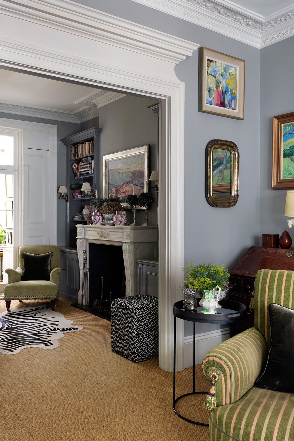 The walls in the sitting rooms are decked out with landscapes by Annabel Fairfax and Kirsty Wither. 'When I finish a job...