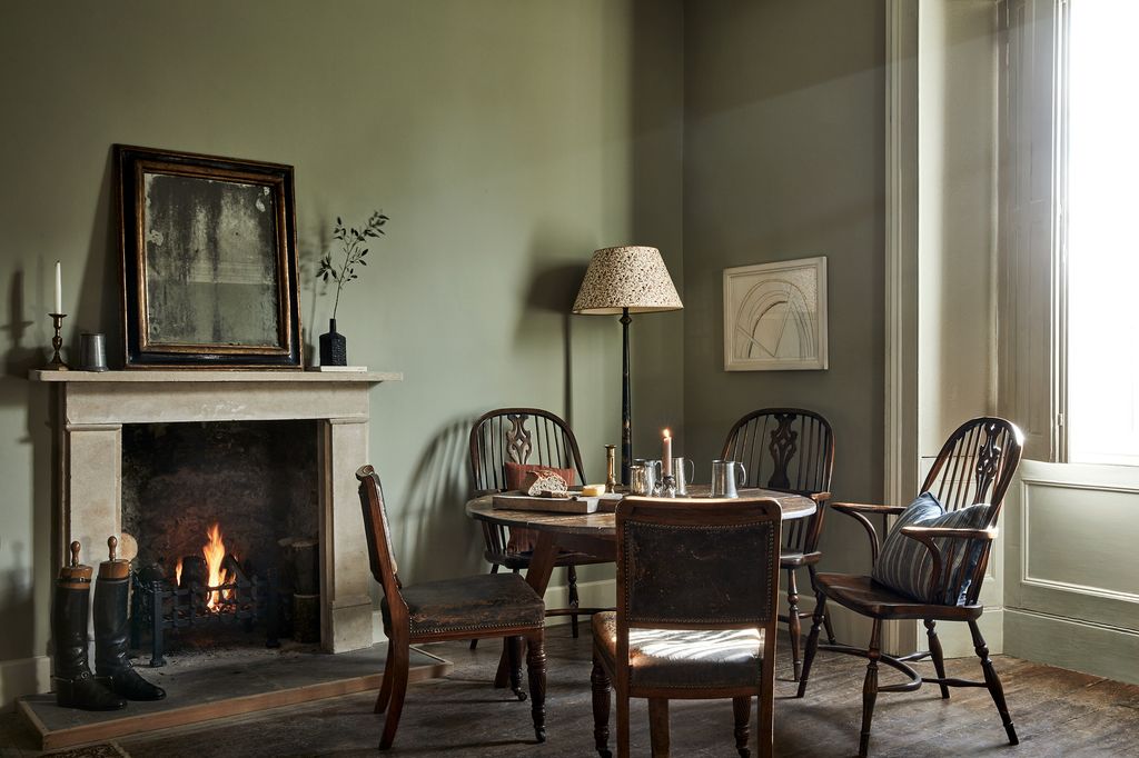 Image may contain Furniture Chair Fireplace Indoors Wood Hearth Living Room Room Hardwood Human and Person