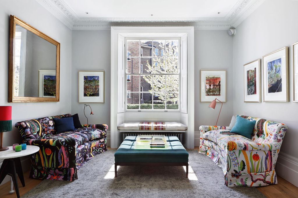 The sofas in the sitting area have been upholstered in fabrics designed by Josef Frank. The window seat between them...