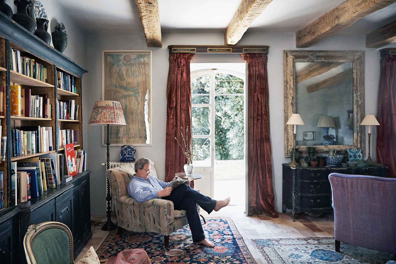 Image may contain Living Room Room Indoors Furniture Human Person Couch Interior Design and Shelf