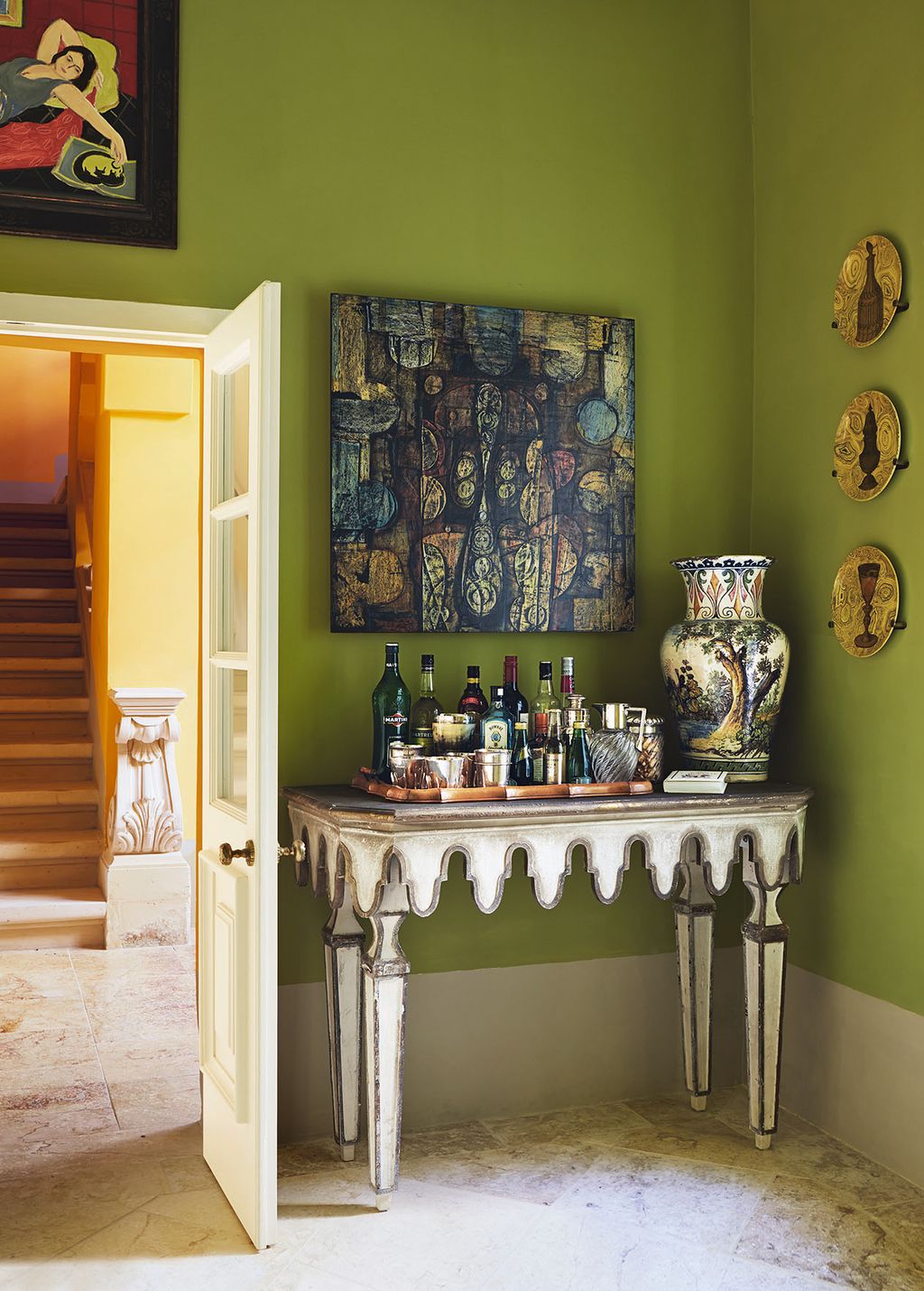 An ornate table from Oka and artwork by Don Woodford and Isobel Brigham decorate the compact ‘drinks room.