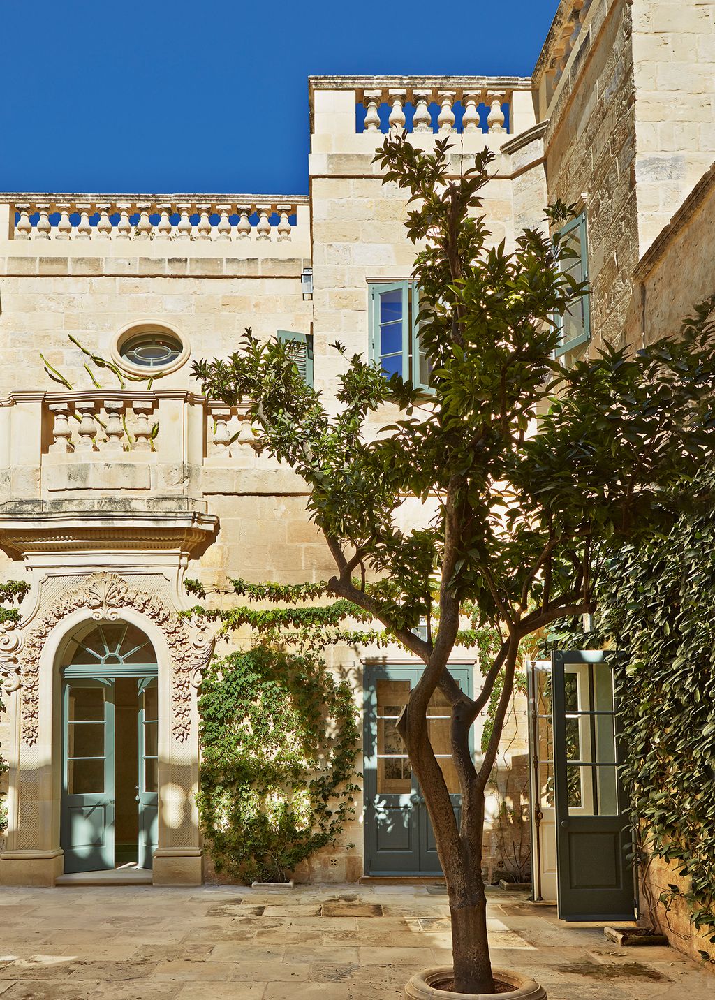French windows provide access to the internal courtyard from most of the rooms on the ground floor while orange trees...