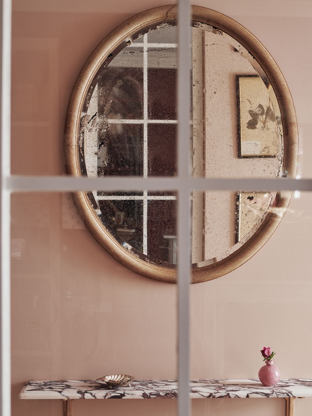 An internal window between the hallway and sitting room provides a view into the calm hallway which is painted in Edward...