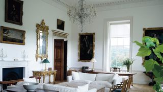 Image may contain Flooring Living Room Room Indoors Furniture Wood Interior Design Hardwood Floor Couch and Table